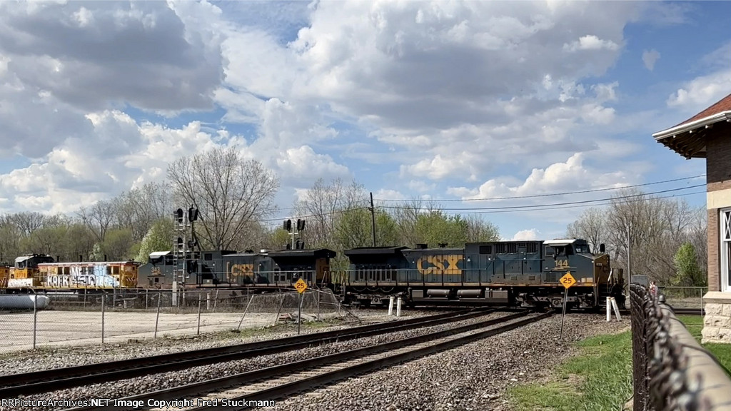 CSX 144 starts east past the depot.